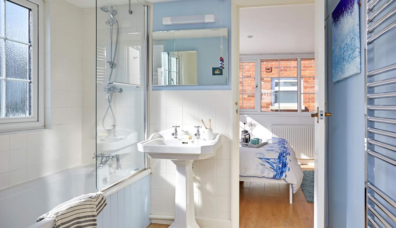 The dual-access bathroom on the first floor has a shower over the bath.