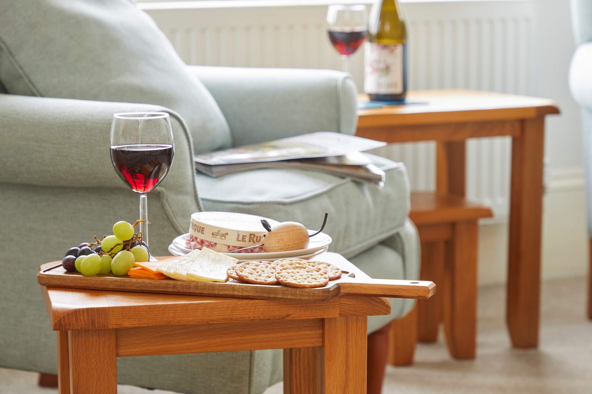Simple pleasures: wine and nibbles by the cosy armchair.