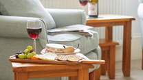 Simple pleasures: wine and nibbles by the cosy armchair.