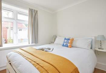 Soft textures and natural light in the ground floor bedroom. 