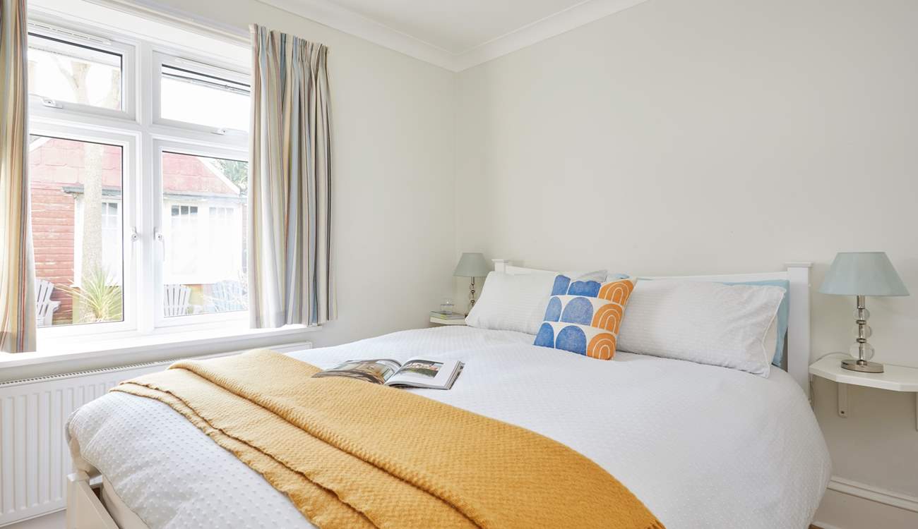 Soft textures and natural light in the ground floor bedroom. 