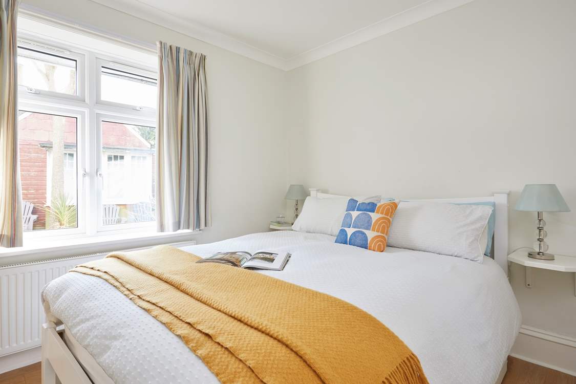 Soft textures and natural light in the ground floor bedroom.