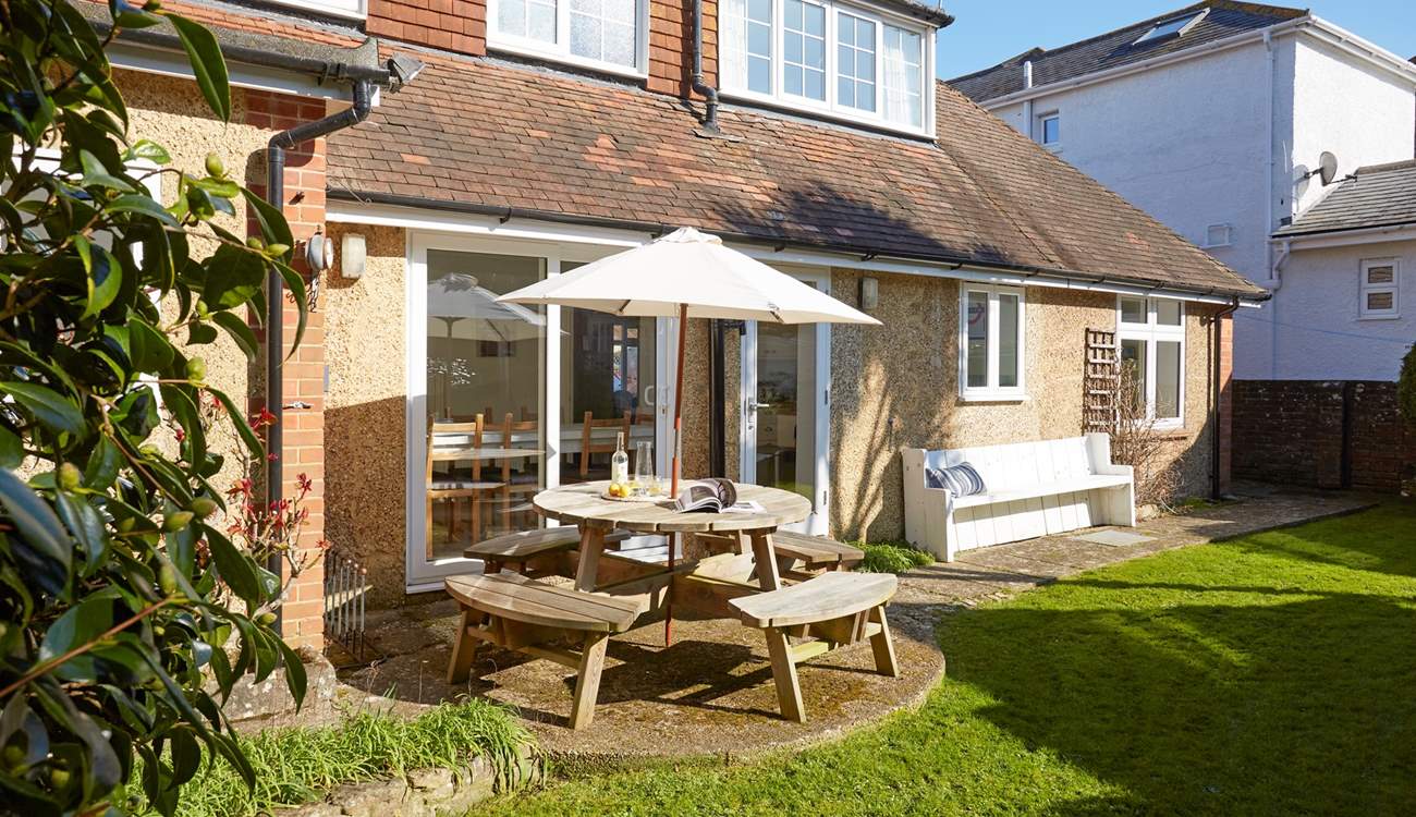 The enclosed garden to the rear of the property is a lovely private spot for enjoying the sunshine with family and friends.