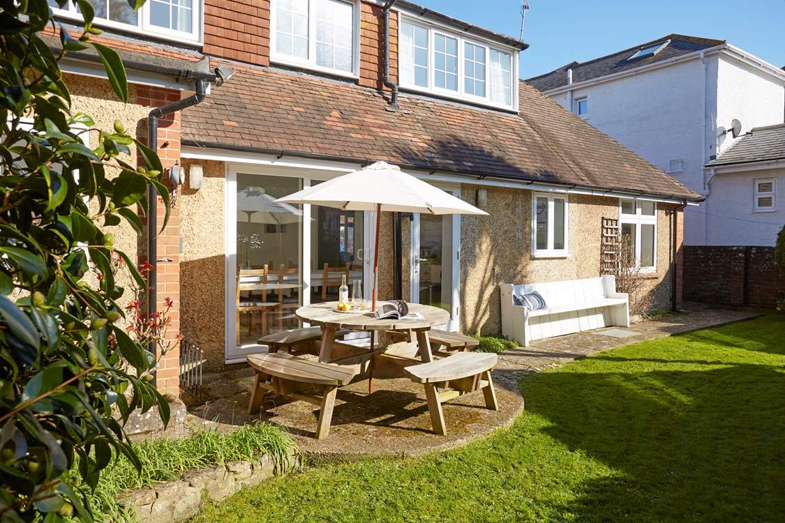 The enclosed garden to the rear of the property is a lovely private spot for enjoying the sunshine with family and friends.