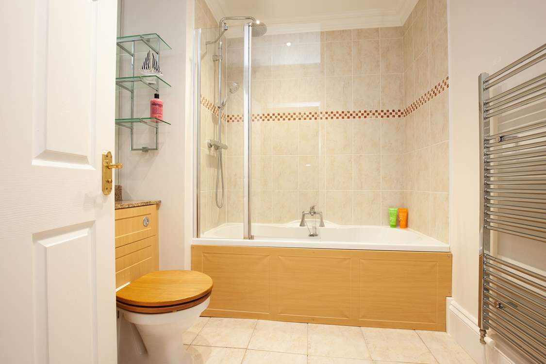 The recently refurbished family bathroom with bath and fitted shower.
