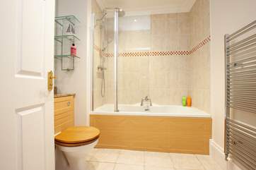 The recently refurbished family bathroom with bath and fitted shower.