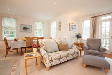 The open plan sitting/dining-room offers plenty of space, as well as doors that open out onto a terrace overlooking the pool.