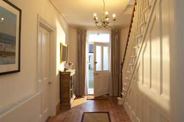 The entrance hall is just off the utility/boot-room, with doors to all downstairs rooms.