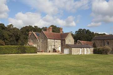 The gravelled driveway leads to the large parking area, to the front of Barton Manor Farmhouse.