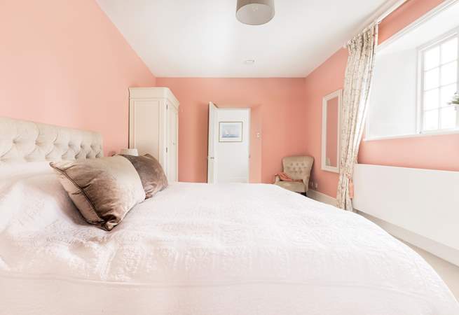 Relax and unwind in the pretty pink bedroom which has zip and link beds so you can choose either twins or a super-king double bed. 