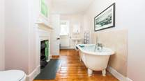 The gorgeous feature bathroom has a roll top bath, perfect for a long soak after a busy beach day. This dual access bathroom sits in between two bedrooms. 