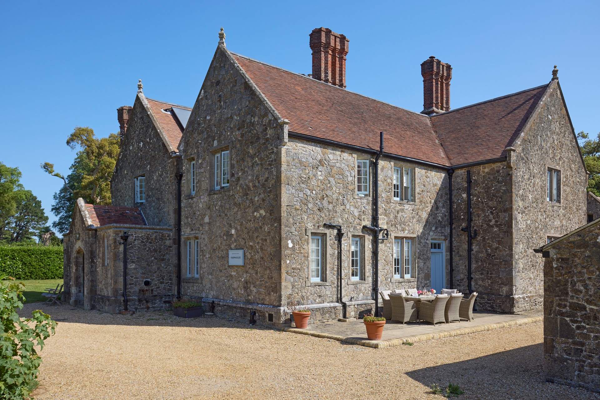 The gravelled driveway leads to the large parking area, to the front of Barton Manor Farmhouse.