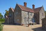 The gravelled driveway leads to the large parking area, to the front of Barton Manor Farmhouse.