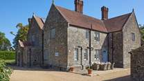 The gravelled driveway leads to the large parking area, to the front of Barton Manor Farmhouse.