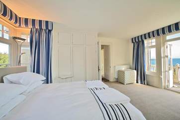 The main bedroom on the first floor has doors to the balcony overlooking Seagrove Bay.