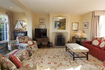 The sitting-room is comfortable and has lovely views both to the front and out towards the garden and bay below.