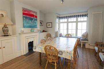 The dining-area at the far end of the enormous kitchen-area has views out to the garden and sea.