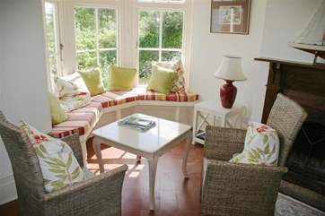 This relaxing spot is in the spacious hallway and has doors out to the garden.