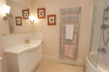 En suite bathroom with a shower over the bath.