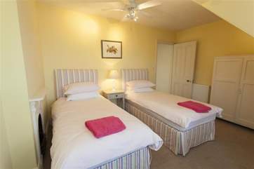 This pretty twin bedroom on the second floor also boasts views across Seagrove Bay.