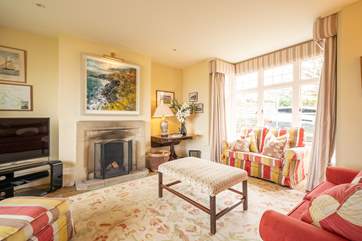 The sitting-room is comfortable and has lovely views both to the front and out towards the garden and bay below.