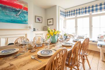 The dining-area at the far end of the enormous kitchen-area has views out to the garden and sea.