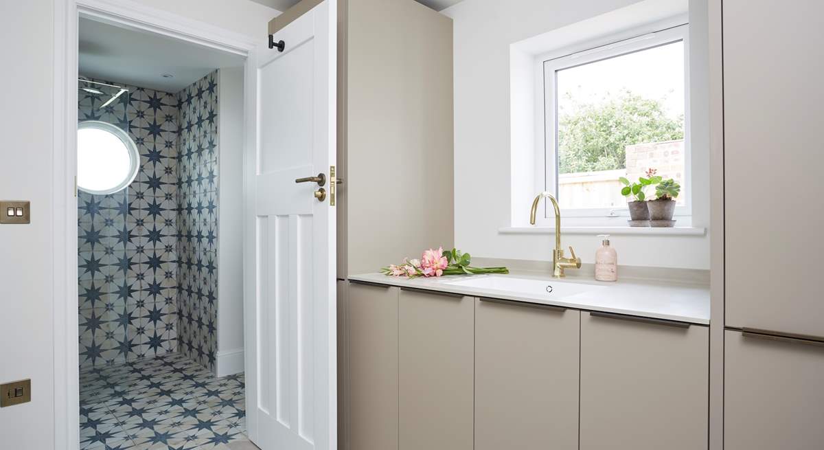 The utility area with an additional integrated fridge/freezer, washing machine and drier leading into the downstairs shower-room.