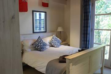 This bedroom on the first floor has views towards the creek.