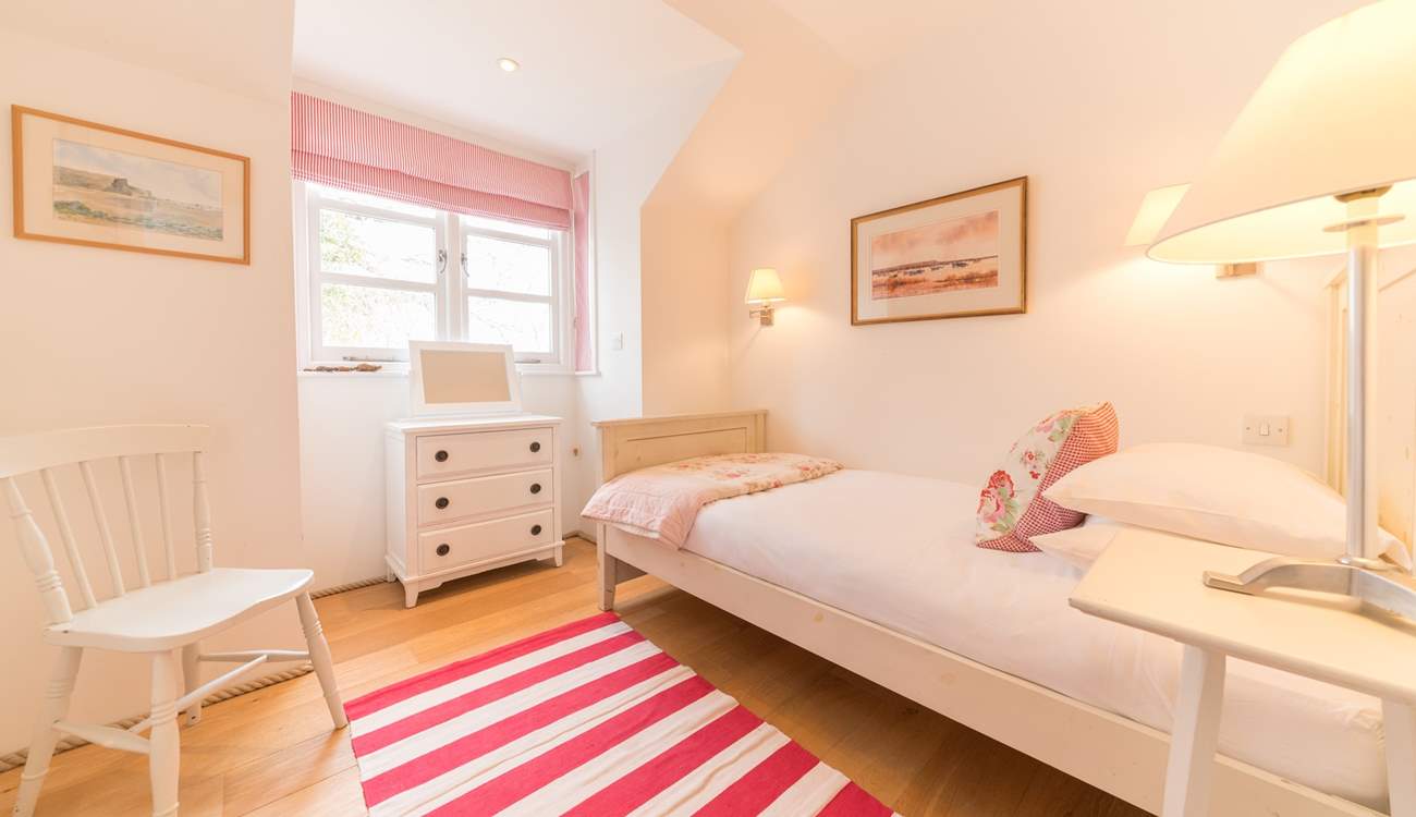 The pretty fifth bedroom located on the first floor.