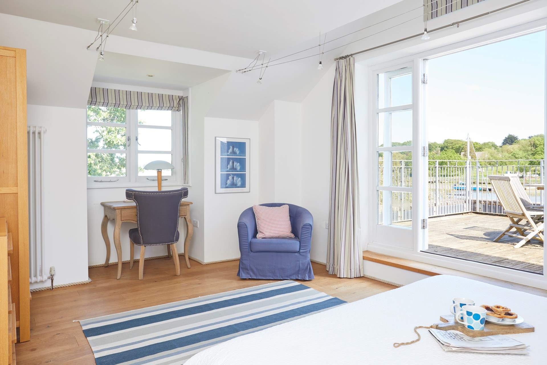 Wake up to the sunrise right from your bed in the main bedroom.