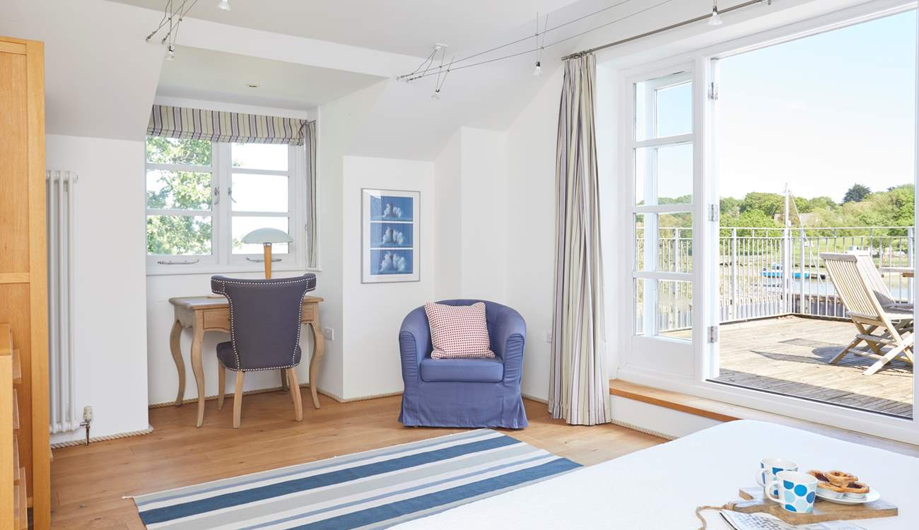 Wake up to the sunrise right from your bed in the main bedroom.