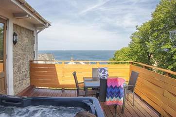 Enjoy a soak in the hot tub with sea views.