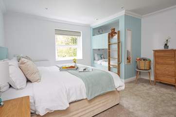 The family bedroom also has an en suite bathroom with corner shower and double hand basins.