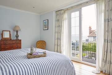 The main bedroom on the first floor showcases stunning sea views.