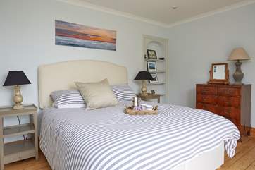 The spacious main bedroom with balcony.