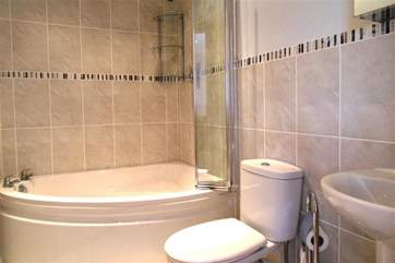 The master bedroom en suite has a corner bath.