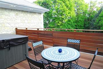 Private decked patio with hot tub and sun loungers.
