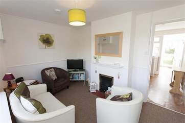 The cosy sitting-room with electric fire.