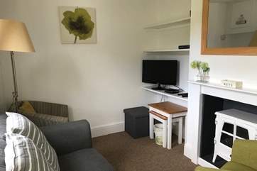 The cosy sitting-room with electric fire.