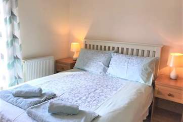 The comfortable main bedroom overlooks the garden.