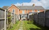 The sunny enclosed garden is ideal for al fresco dining. - Thumbnail Image