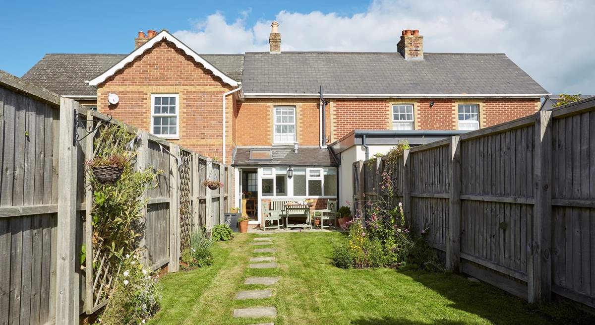 The sunny enclosed garden is ideal for al fresco dining.