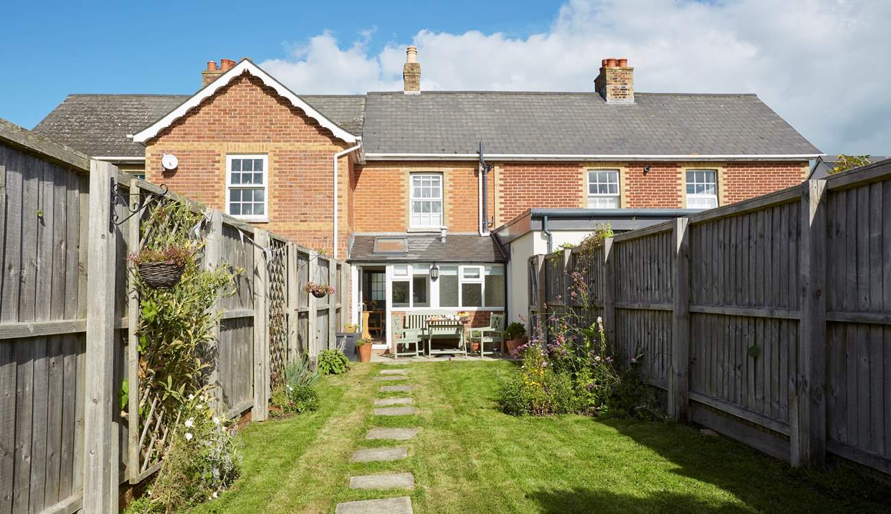 The sunny enclosed garden is ideal for al fresco dining.