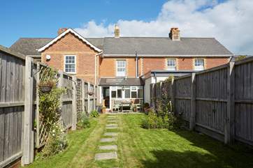 The sunny enclosed garden is ideal for al fresco dining.