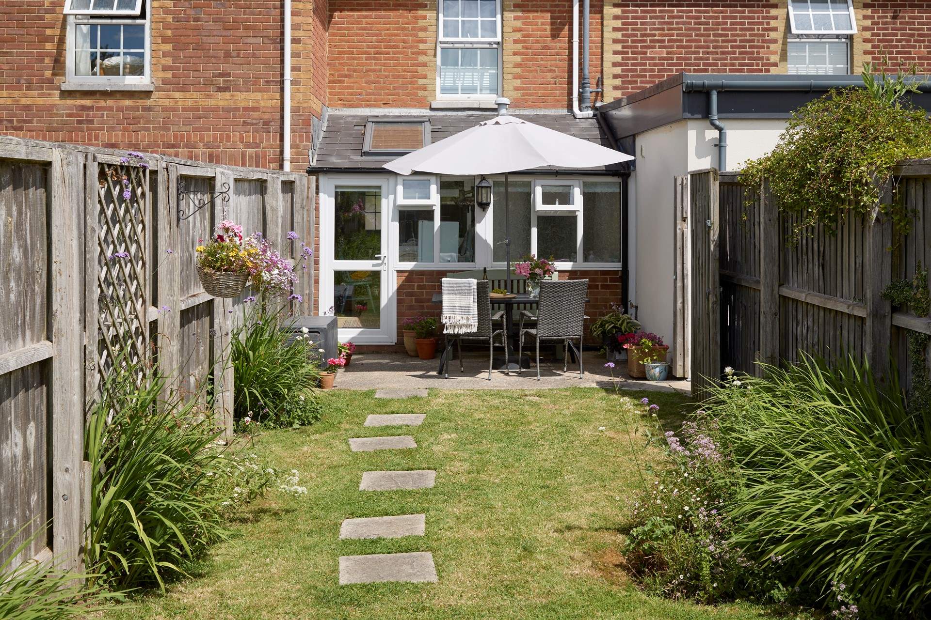 The sunny enclosed garden is ideal for al fresco dining.