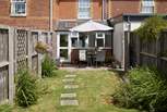 The sunny enclosed garden is ideal for al fresco dining.