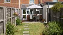 The sunny enclosed garden is ideal for al fresco dining.