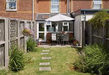 The sunny enclosed garden is ideal for al fresco dining.