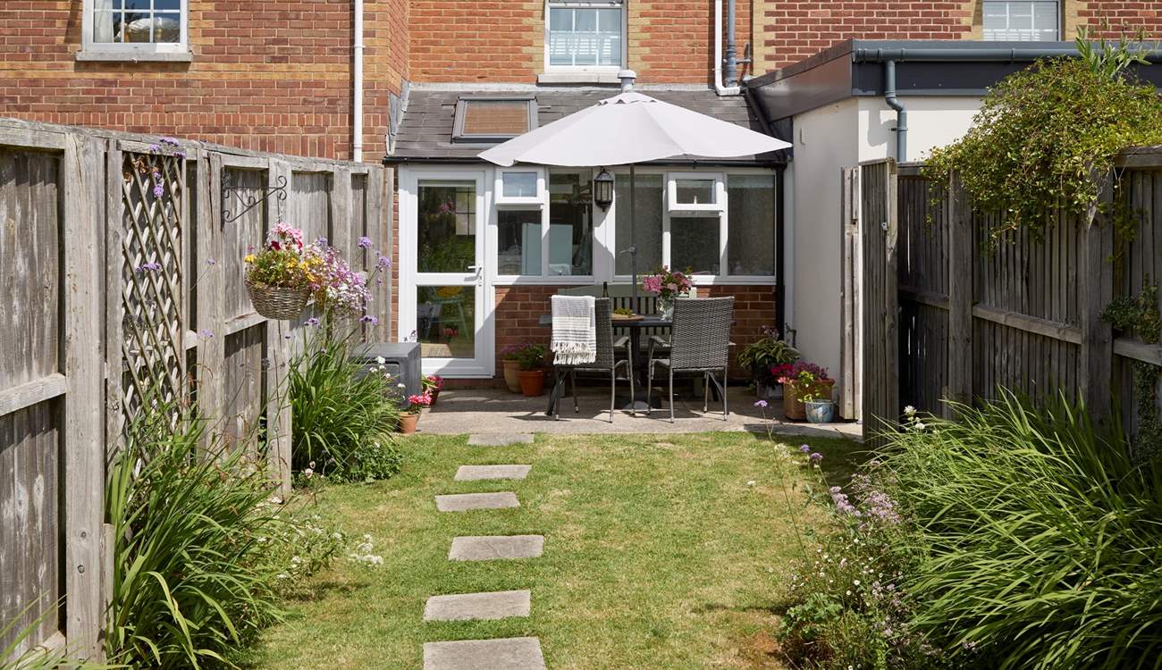 The sunny enclosed garden is ideal for al fresco dining.