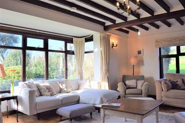 A lovely bright and spacious sitting-room, ideal for large families.